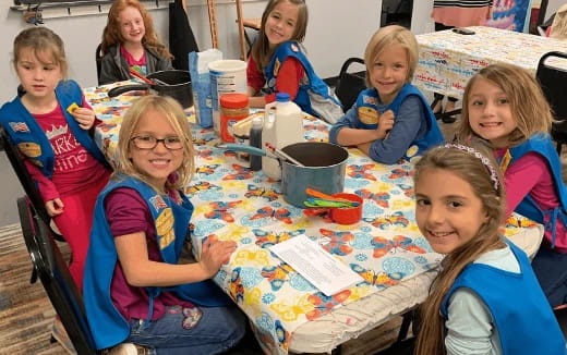 a group of children sitting at a table
