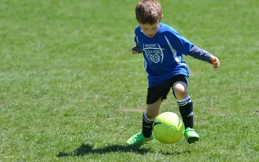 a young boy playing football