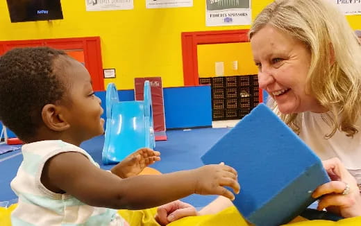 a woman and a child reading a book