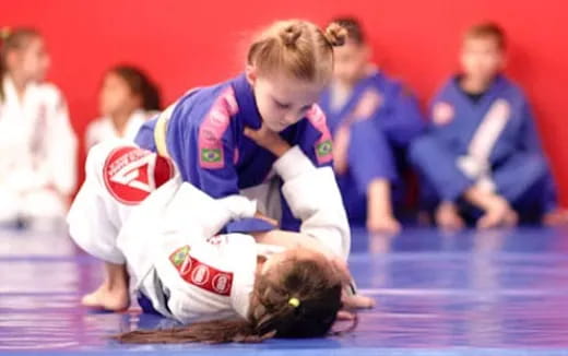 a couple of kids in karate uniforms