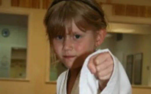 a boy with his hand on his chin