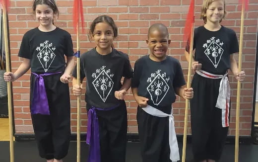 a group of children holding sticks