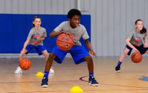 a group of kids playing basketball