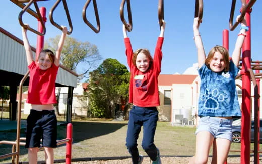 a group of children on a swing set