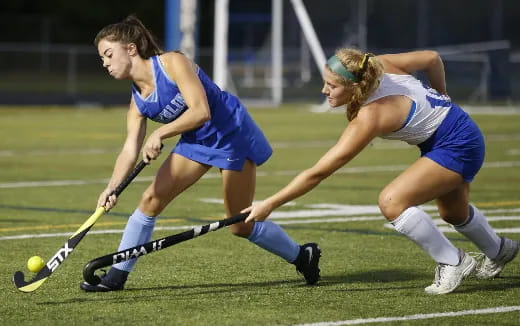 women playing field hockey