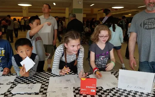 a group of people looking at papers