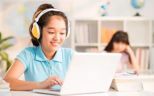 a young girl using a laptop