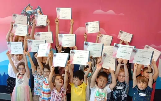 a group of children holding up signs