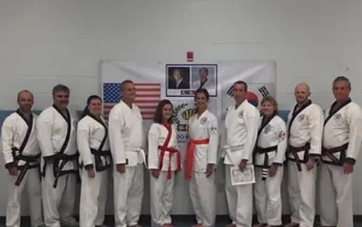 a group of people in white karate uniforms