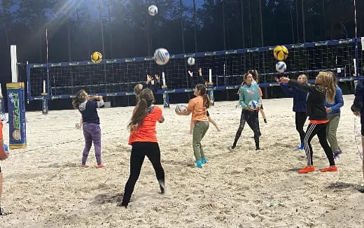 a group of people playing volleyball