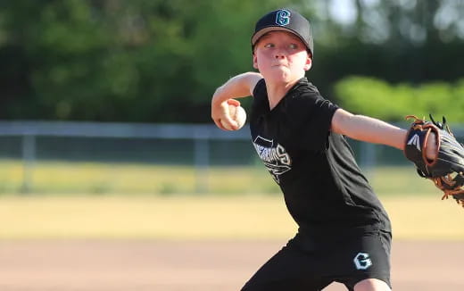 a boy throwing a baseball