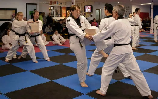 a group of people in karate uniforms