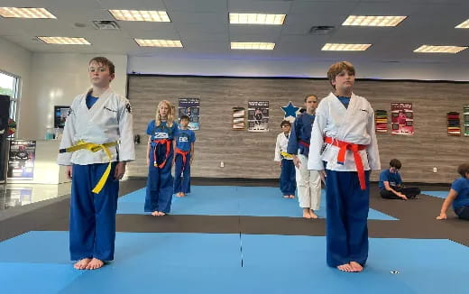 a group of people in karate uniforms