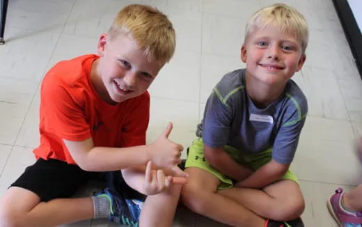 two boys sitting on the floor