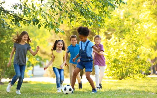 a group of kids playing football