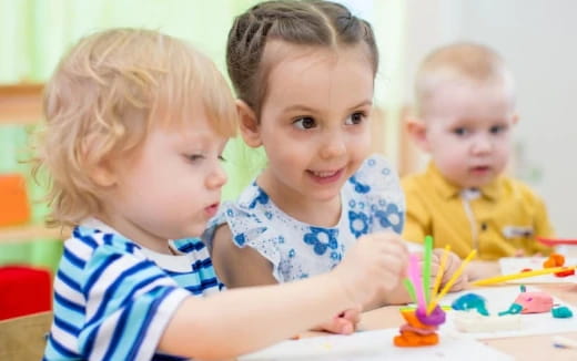 a group of children sitting at a table