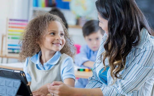 a person and a child looking at a computer screen