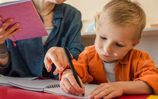 a child writing on a book