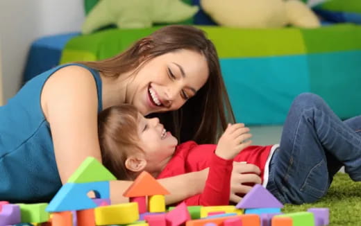 a person and a child playing with toys