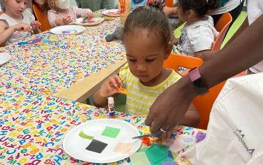 a child coloring on a paper