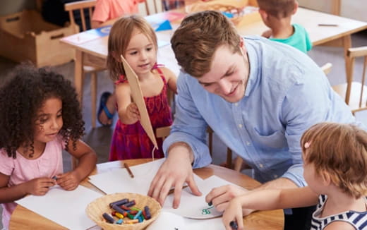 a person and children sitting at a table