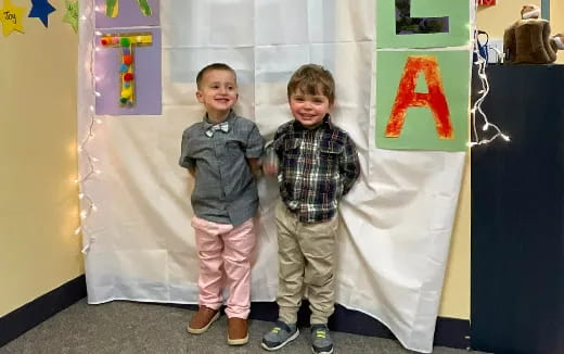 two boys standing next to each other