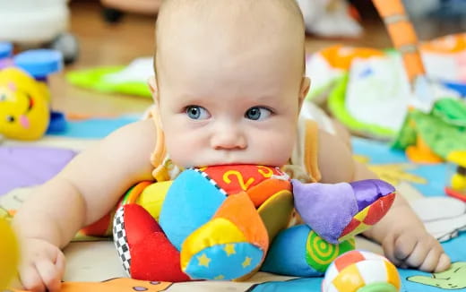 a baby lying on a blanket