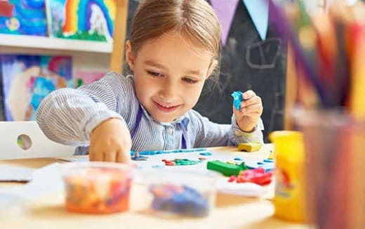 a child painting on a table