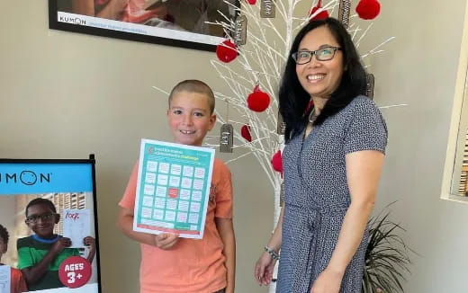 a person and a boy holding a picture frame