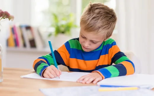 a child writing on a book
