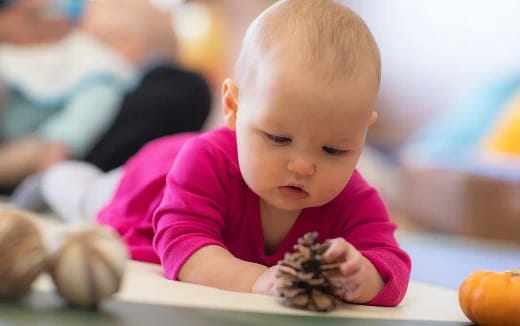 a baby looking at a book