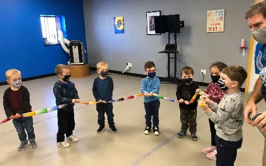 a group of children holding a rope