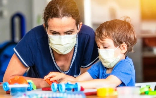 a person and a child playing with toys
