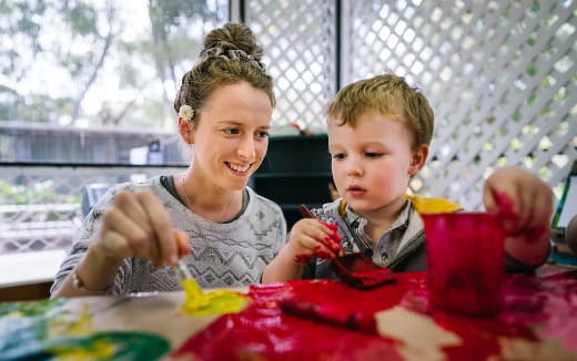 a person and a boy sitting at a table