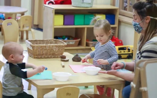 a person and a child playing with a toy