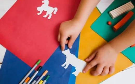 a person drawing on a piece of paper