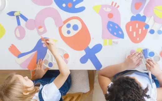 children painting on a wall