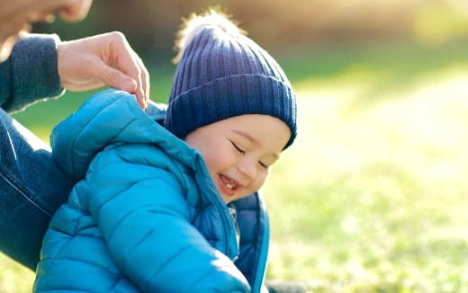 a child in a blue jacket
