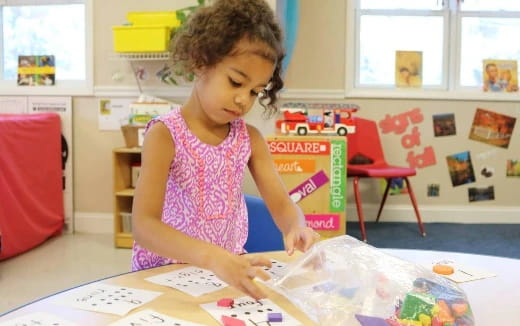 a young girl coloring on a paper