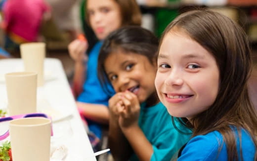 a group of children sitting at a table