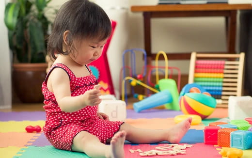 a baby girl playing with toys
