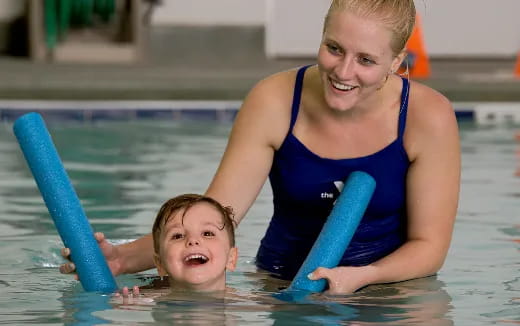 a woman and a child in a pool