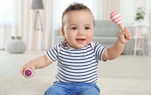 a baby holding a toy