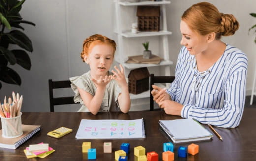 a person and a child sitting at a table