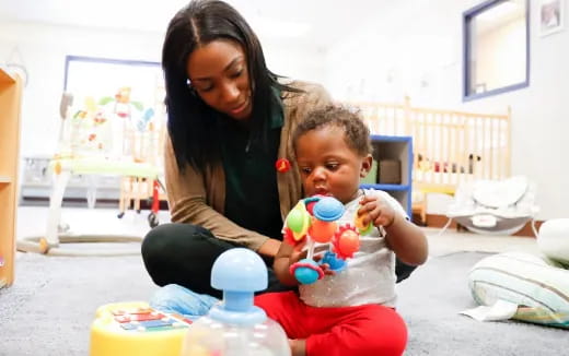 a person and a child playing with toys