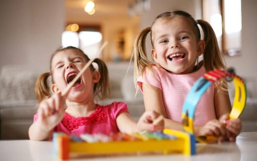 a couple of young girls playing with toys