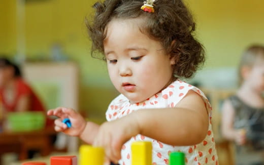 a little girl playing with toys