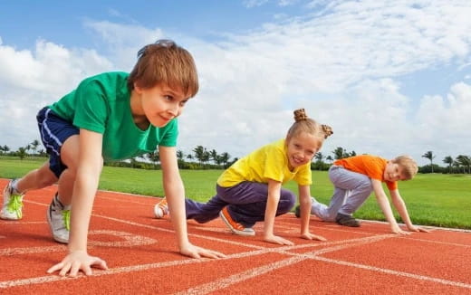 a group of kids playing on a track