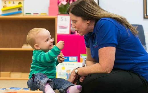 a person feeding a baby