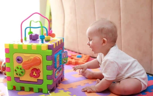 a baby playing with a toy